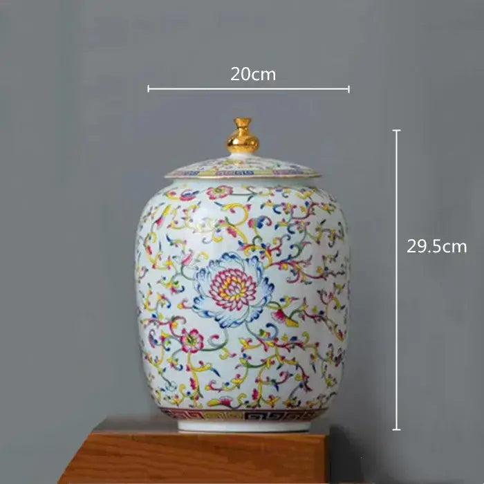 White enamelled porcelain tea caddy ginger jar with multicolored floral patterns and gold-toned lid for dining room use