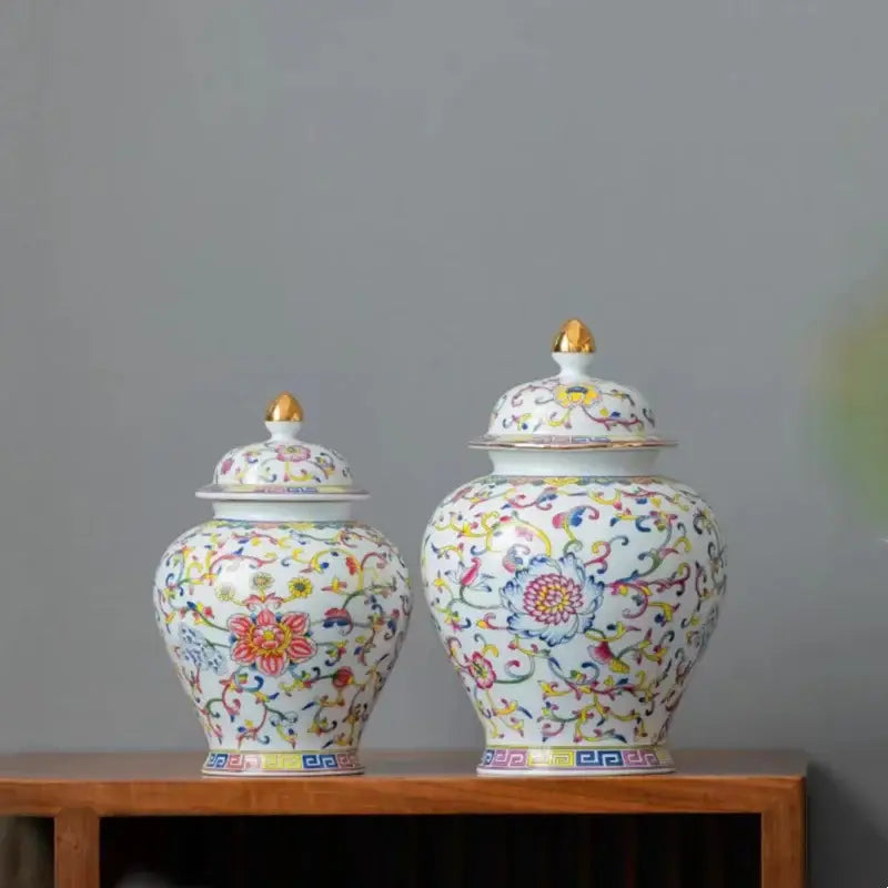 Two ornate floral white enamelled porcelain tea caddy ginger jars with gold-tipped lids for dining room use