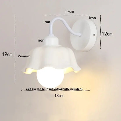 Floral white glass wall sconce with a white ceramic fluted shade and iron bracket featuring a pull chain switch wall sconce