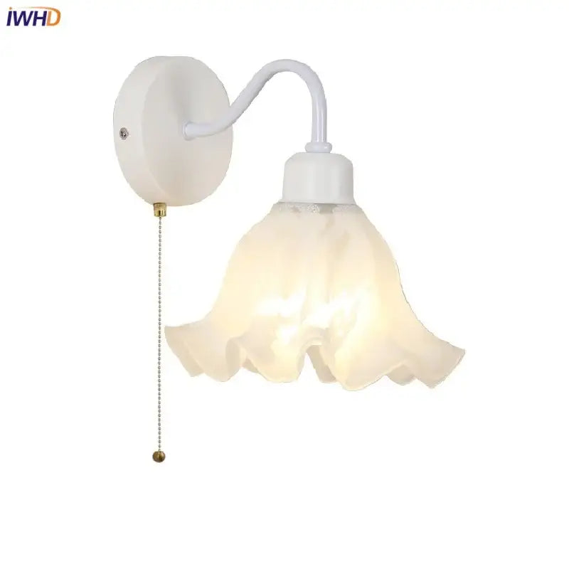 Floral white glass wall sconce with frosted flower shade and pull chain switch for stair lighting