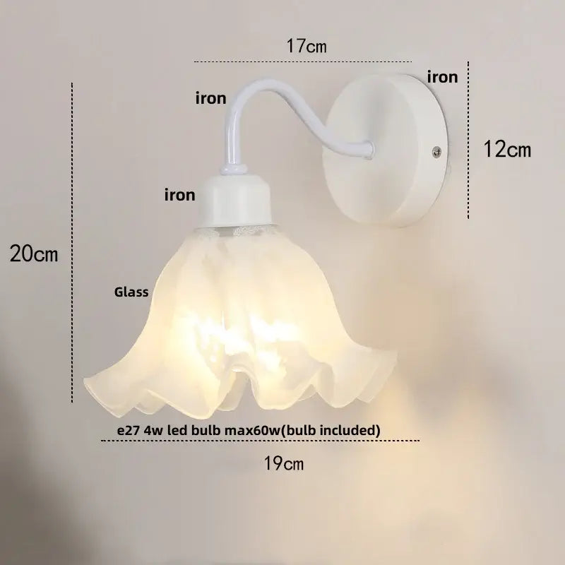 Floral white iron wall sconce with translucent ruffled glass shade and pull chain switch for stair light use