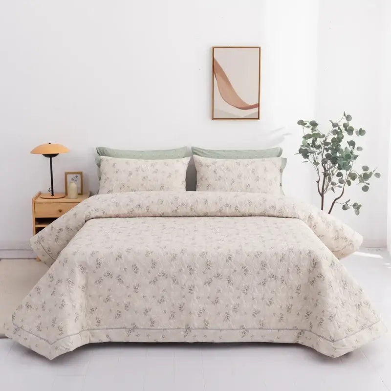Beige floral quilted cotton bed cover set with subtle green accents and soft textured fabric finish for bedroom use