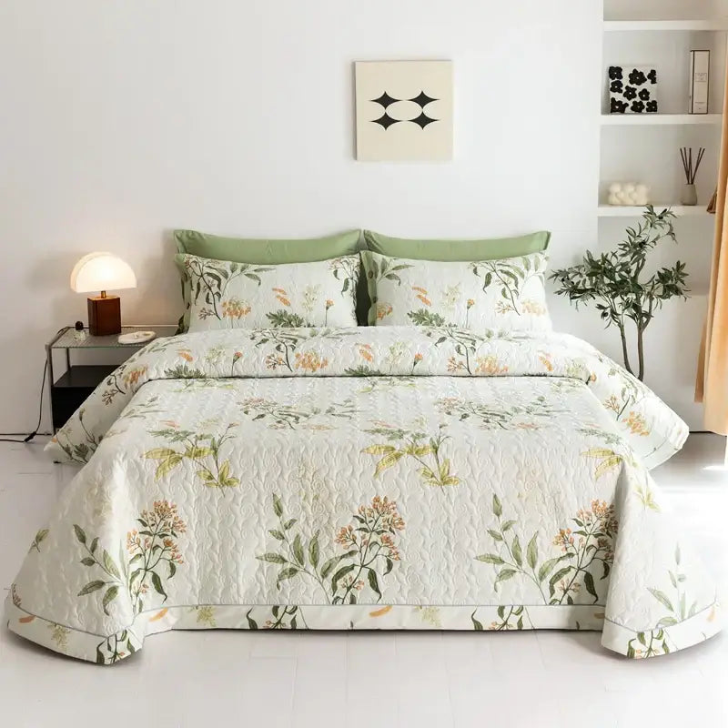 Soft cream-colored cotton bed cover set with delicate green leaves and orange blossoms botanical quilted design