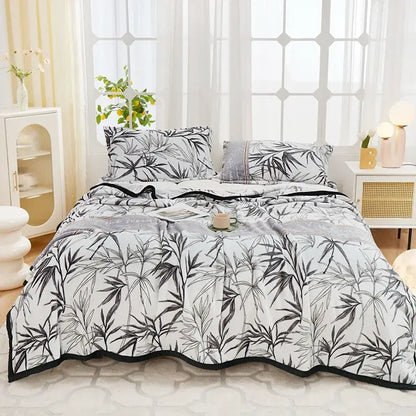 White bed set with black bamboo leaf pattern and trim paired with decorbites cozy flannel plush bedroom throw