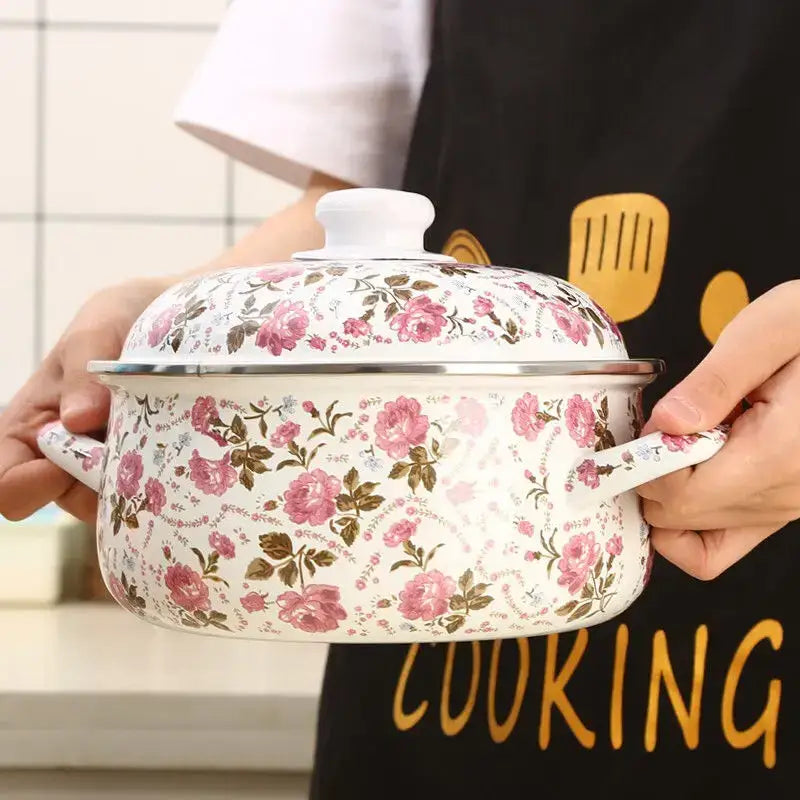 A white enamel ceramics soup saucepan with pink and brown floral patterns and a matching lid with stainless steel rim