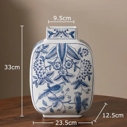 White porcelain vase with intricate blue floral and bird patterns, square neck, rounded body for living room decor