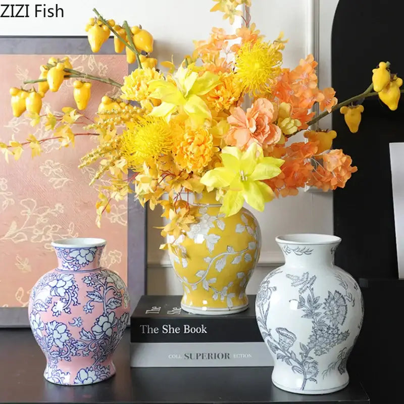 Yellow ceramic porcelain vase with white floral patterns holding vibrant yellow and orange flowers for living room decor