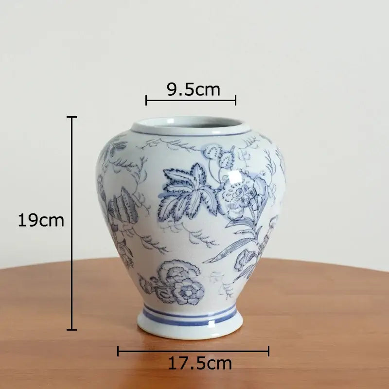 Floral yellow and white porcelain vase with blue floral patterns and rim, a white porcelain vase for living room decor