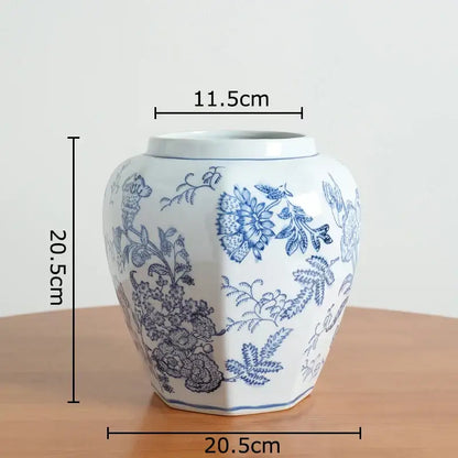 White porcelain vase with intricate blue floral patterns and hexagonal base for living room decor