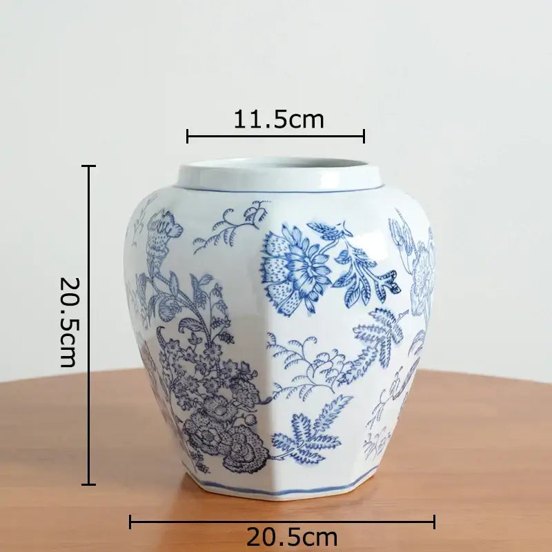 White porcelain vase with intricate blue floral patterns and hexagonal base for living room decor