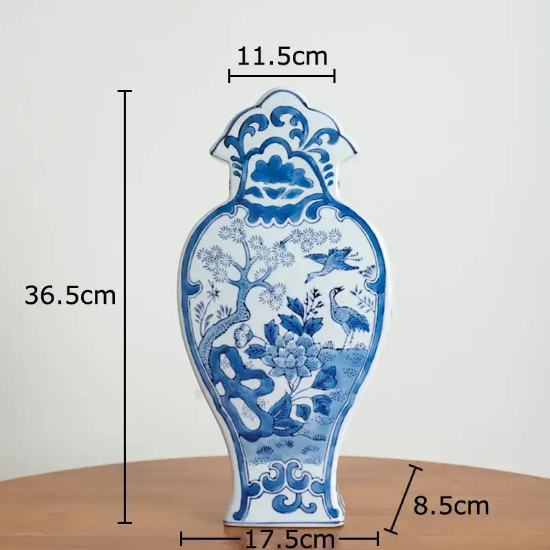 A classic blue and white porcelain vase with intricate hand-painted birds and flowers for living room decor