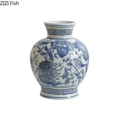 A classic blue and white porcelain vase with intricate floral and bird motifs and greek key border for living room decor