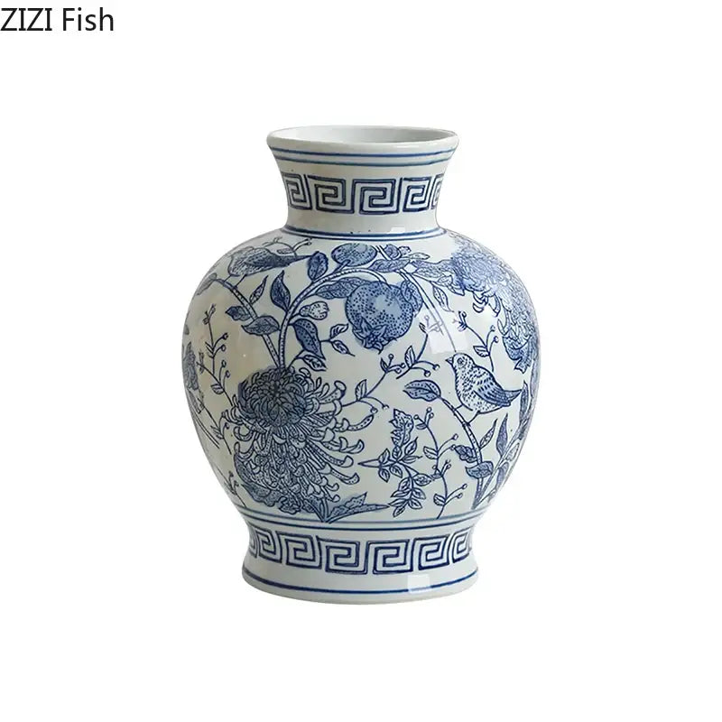 A classic blue and white porcelain vase with intricate floral and bird motifs and greek key border for living room decor