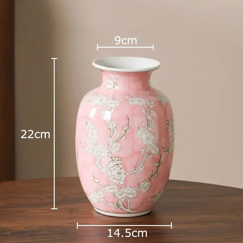 A delicate pink porcelain vase with white floral patterns and a glossy finish for living room decor