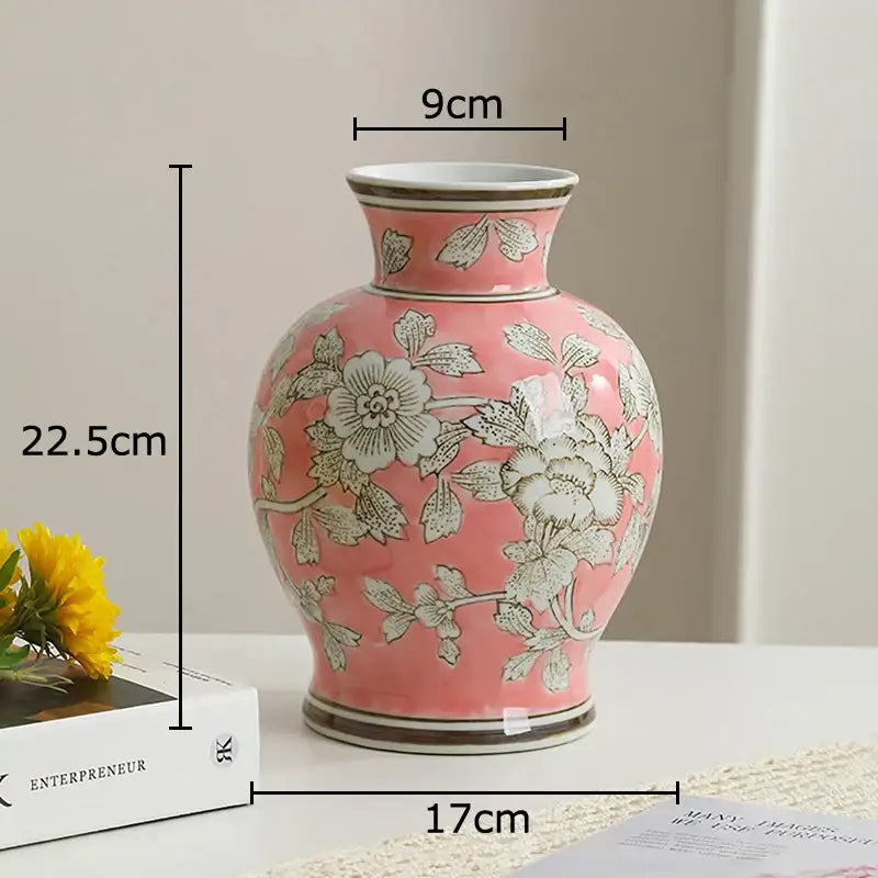 A pink porcelain vase with delicate silver floral patterns and gold-trimmed rim for living room decor