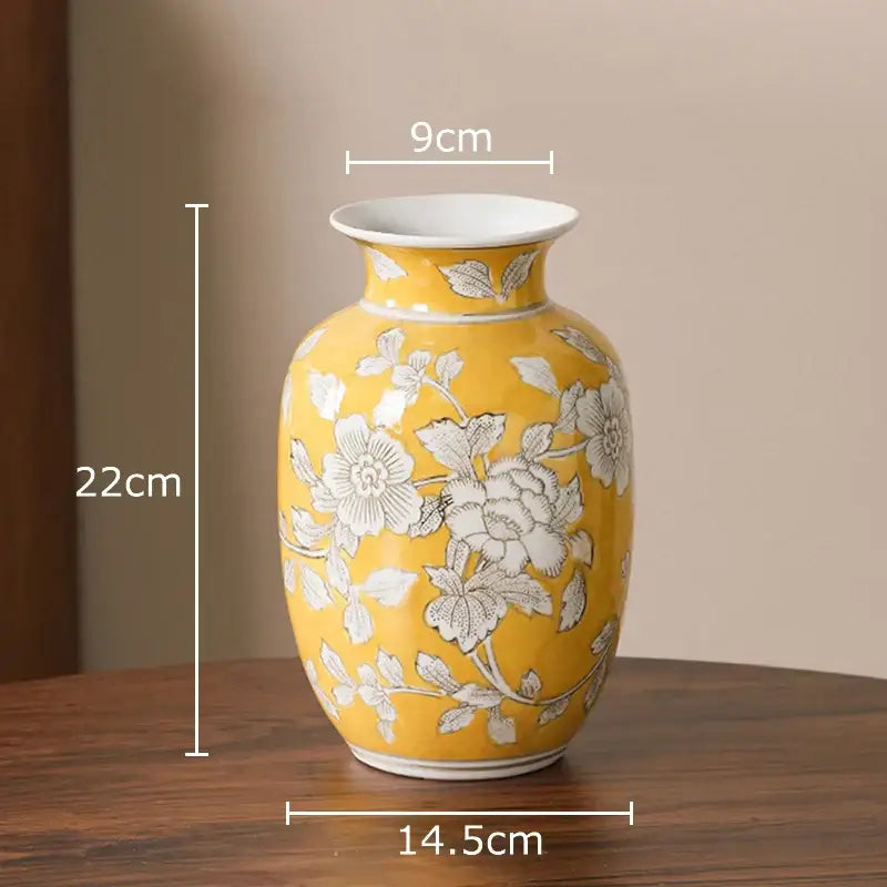A vibrant yellow porcelain vase with delicate white floral patterns ideal for living room decor