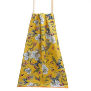 A vibrant yellow cotton gauze floral drawstring bag with white flowers, pink blossoms, and butterflies for decorbites bath towel wrap