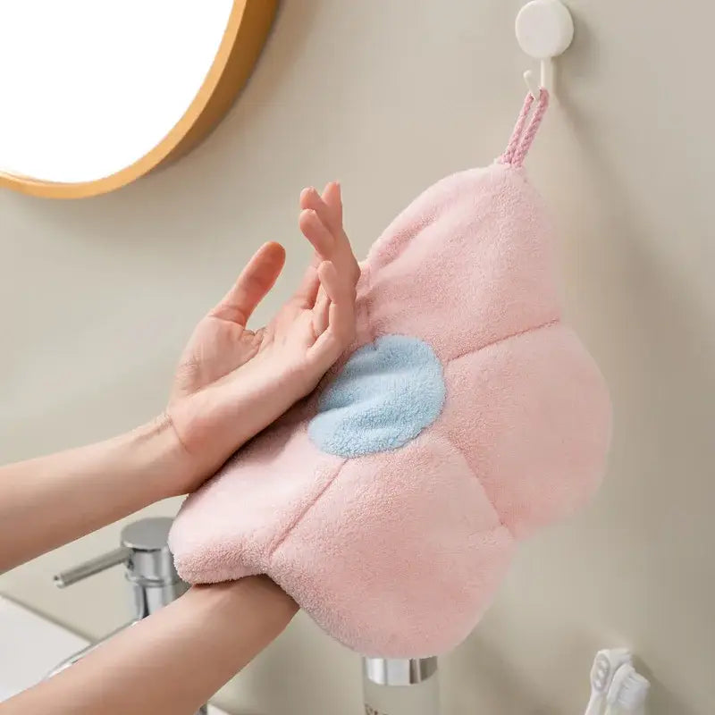 Flower shaped pink and light blue coral fleece hand towels featuring a plush design with a scrubbing pad center