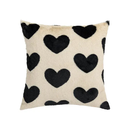 Cream-colored faux fur pillow cover with black heart appliqués for decorbites fluffy comfort pillow in avocado green living room decor