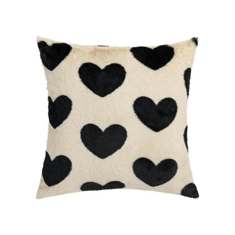Cream-colored faux fur pillow cover with black heart appliqués for decorbites fluffy comfort pillow in avocado green living room decor