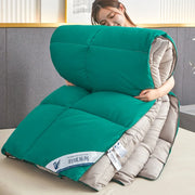 Teal and beige quilted down comforter with swan logo label featuring quilt code for lightweight warm winter use