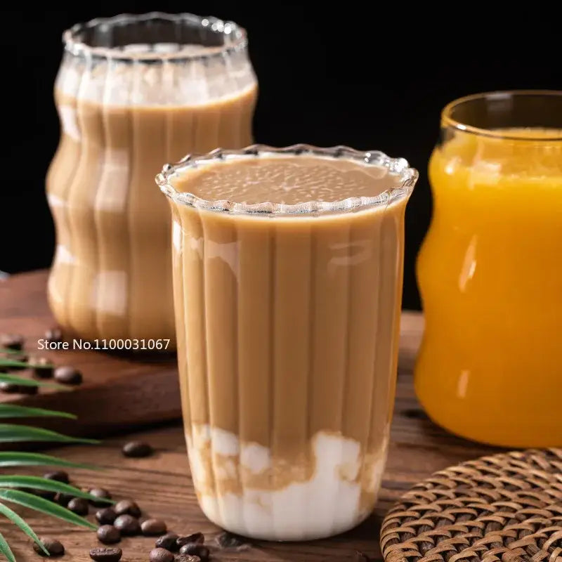 Fluted clear glass coffee mug set with ribbed tumblers filled with creamy coffee topped with white pearls decorbites glass coffee