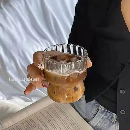 Clear glass coffee mug with fluted rim and wooden base filled with iced coffee from decorbites coffee mug set