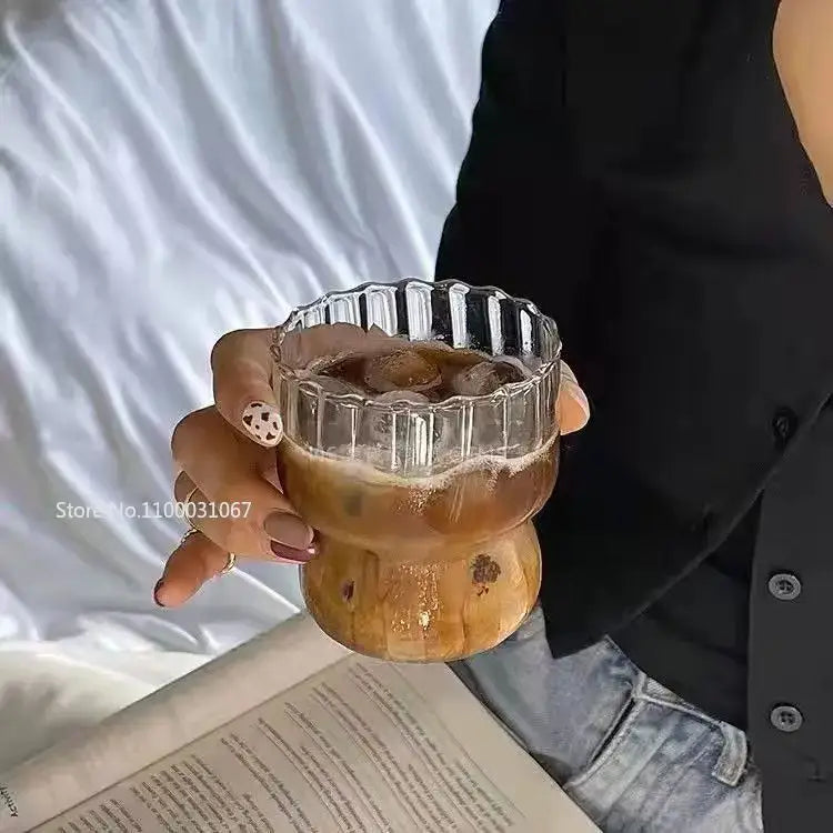 Clear glass coffee mug with fluted rim and wooden base filled with iced coffee from decorbites coffee mug set
