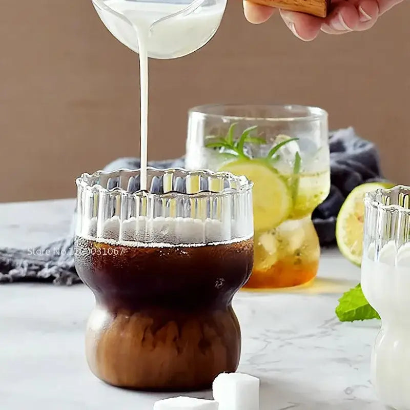 Clear glass coffee mug with fluted rim and bulbous base filled with dark coffee from decorbites coffee mug set
