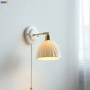 Fluted cream ceramic wall lamp with brass accents by decorbites ideal as a bathroom light and ceramic wall lamp decor