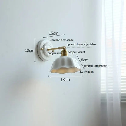 Fluted cream ceramic wall lamp with brass accents featuring a white ceramic lampshade and ruffled edge decorbites ceramic wall