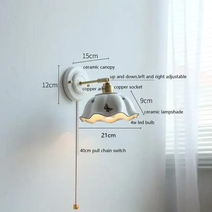 Fluted cream ceramic wall lamp with brass accents featuring a butterfly-decorated fluted ceramic wall lamp shade