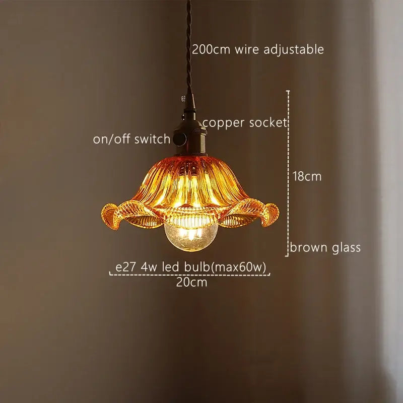 A warm amber fluted pendant light with green stripe glass and exposed led bulb by decorbites for kitchen decor