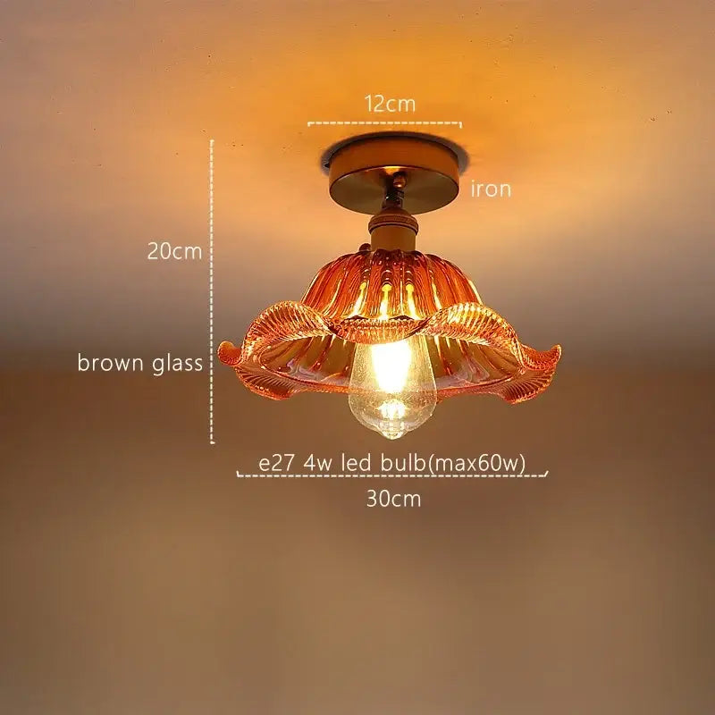 A warm-toned pendant light with brown glass shade and iron base for decorbites green stripe glass kitchen fixture