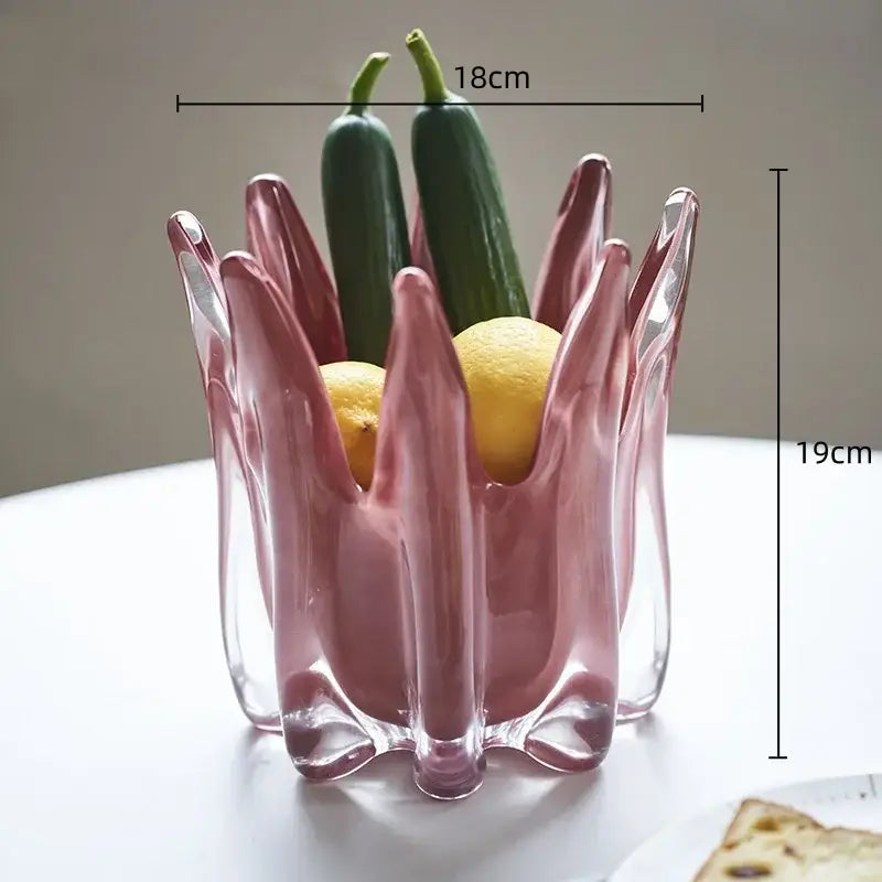 A translucent pink glass fruit bowl with sculpted petal design and clear base perfect for decorbites geometric bud decor