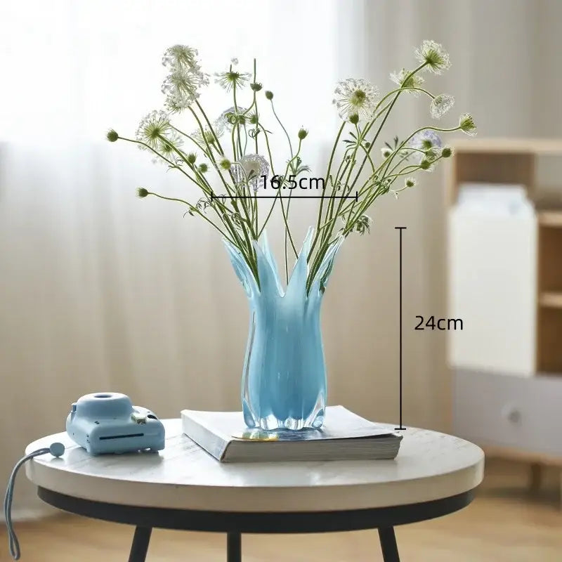 A translucent light blue geometric bud glass vase with a fluted petal rim and faceted base for decorbites decor