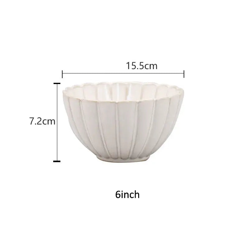 A white ceramic dinnerware set bowl with fluted petal rim and vertical ridges featuring decorbites ceramic white glaze