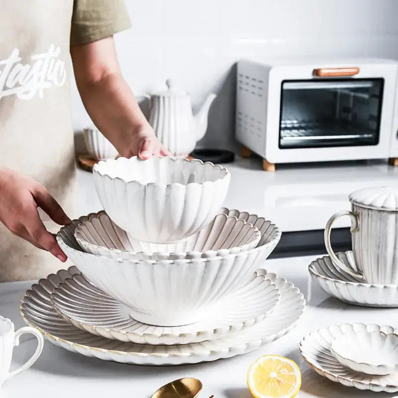 White ceramic dinnerware set bowl with fluted petal rim and gold trim featuring decorbites ceramic white glaze
