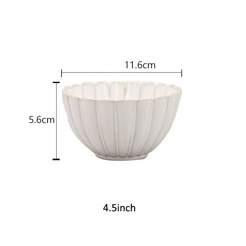 A white ceramic bowl with a fluted petal rim and vertical ridges from decorbites ceramic white dinnerware set