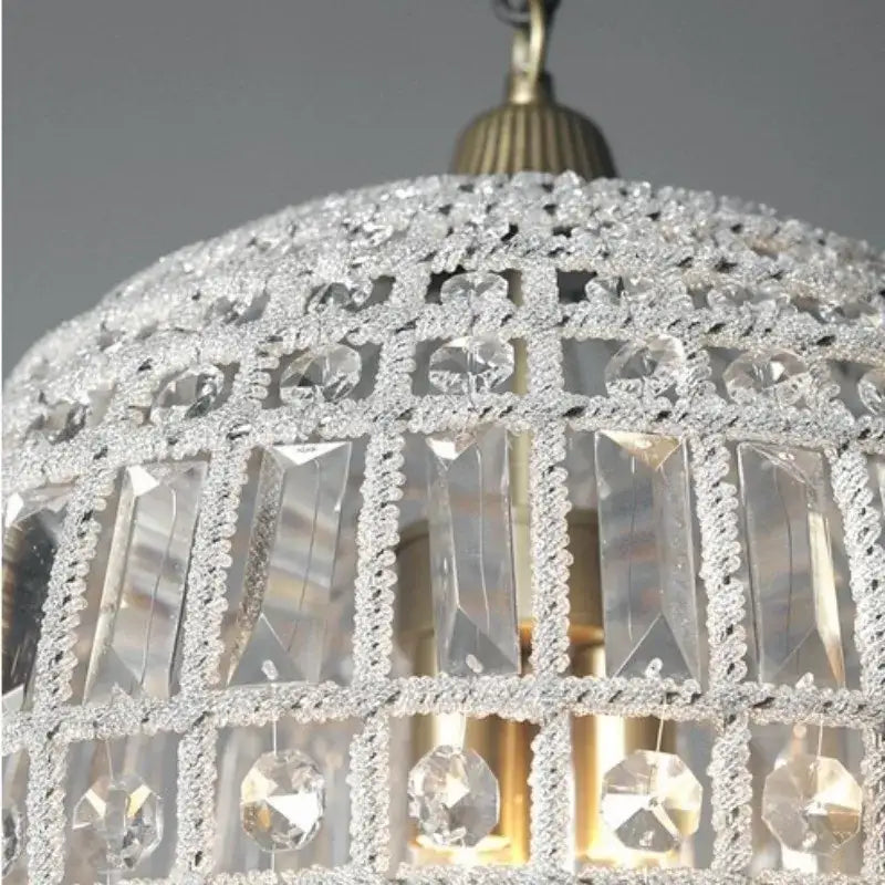 A sparkling crystal pendant light with gold-toned metal frame and lattice design decorbites french balloon crystal