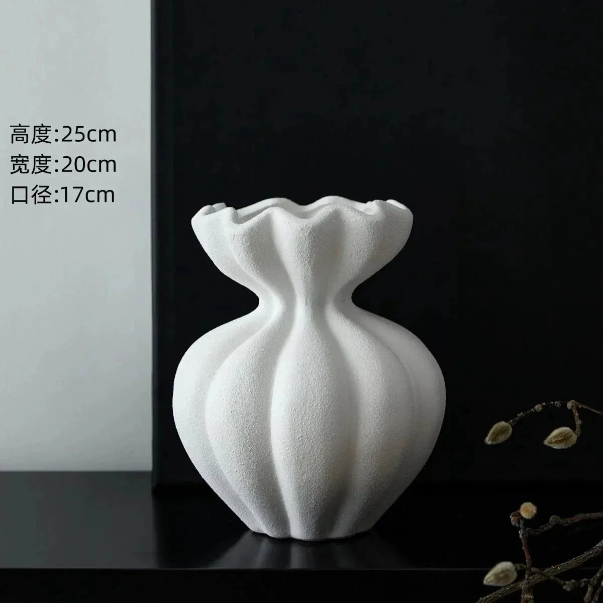A white ceramic French vase with a fluted ruffled rim and vertical ridges for minimalist home decor or gift