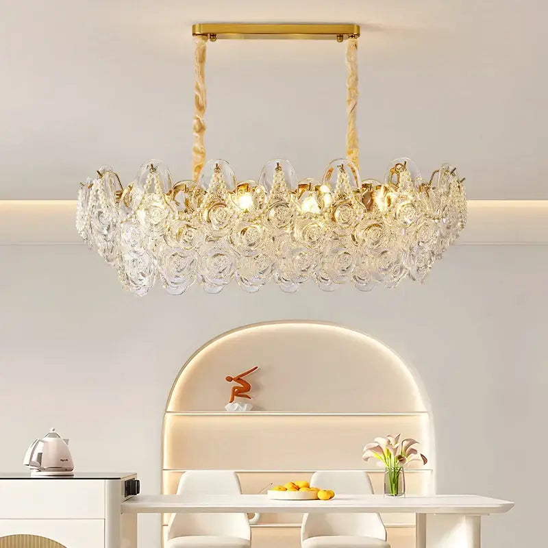 A gold-toned decorbites french chandelier pendant light with crystal pearl rose embellishments for bedroom decor