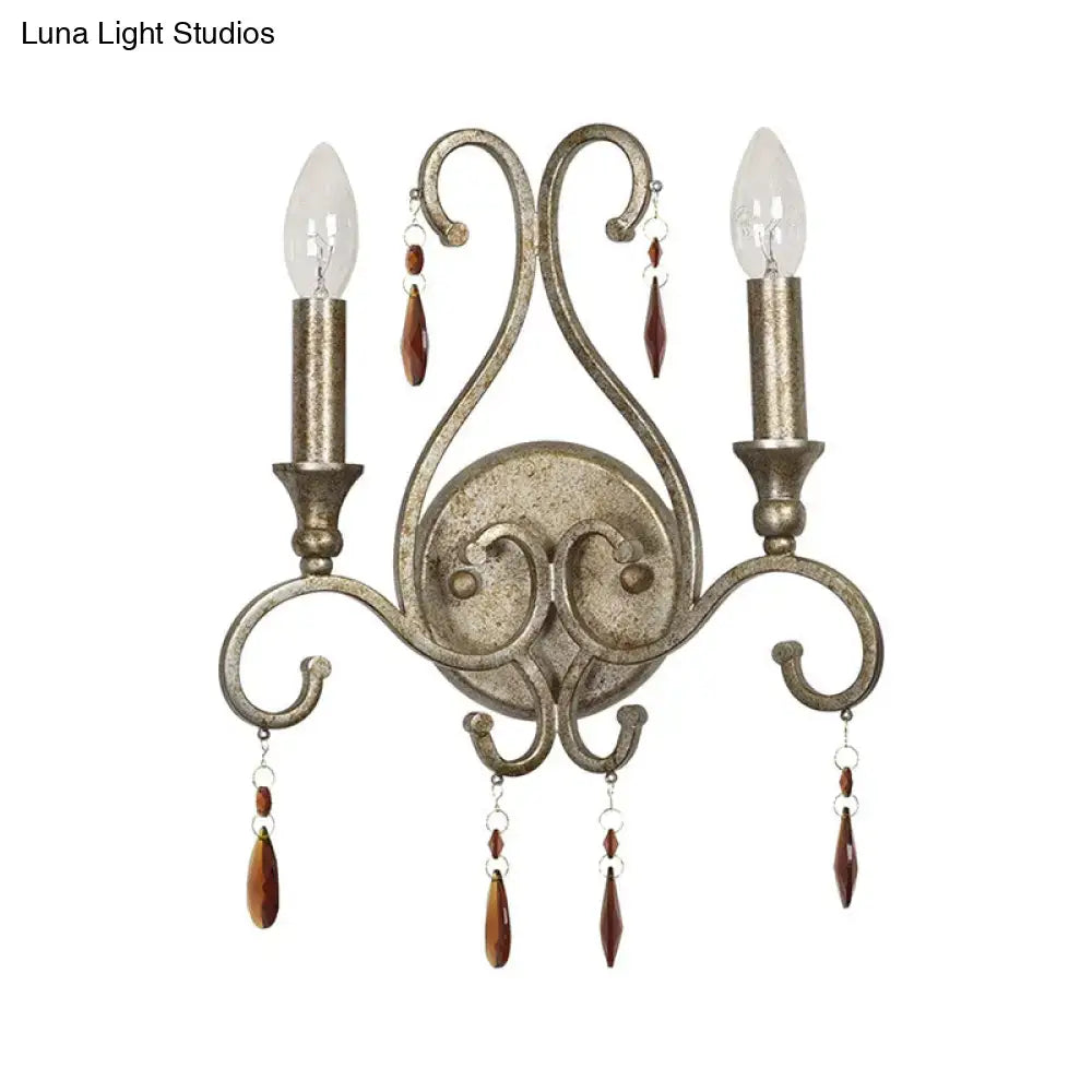 Antique aged silver wall lamp with wrought iron design crystal deco and two candle-style bulbs for dining room