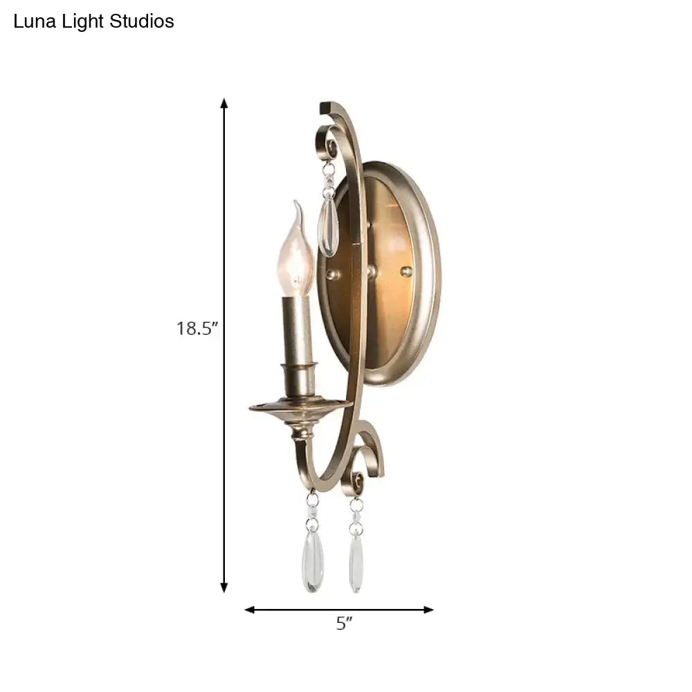 Antique brass finish sconce light with curved ornate design and crystal teardrop pendants for bedroom wall lamp