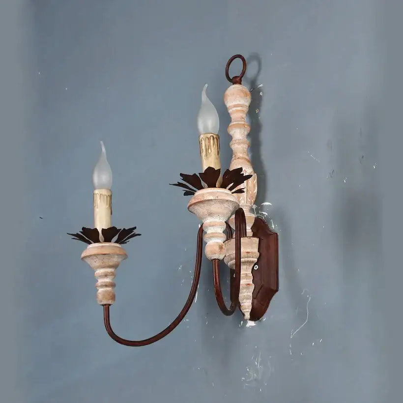 Antique retro wall sconces with distressed white and brown metal frame and dark leaf accents for bedroom wall lamps