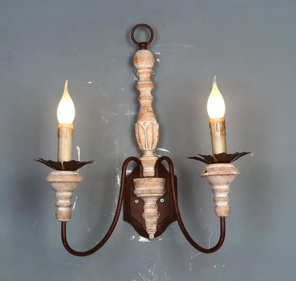 French country distressed white antique retro wall sconces with dark metal accents and two candle-like bulbs for bedroom use