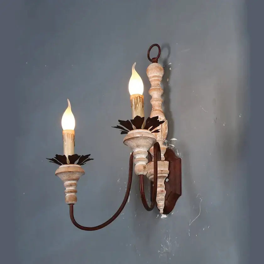 French country distressed white antique retro wall sconces with two candle-like bulbs and dark leaf metal accents for bedrooms