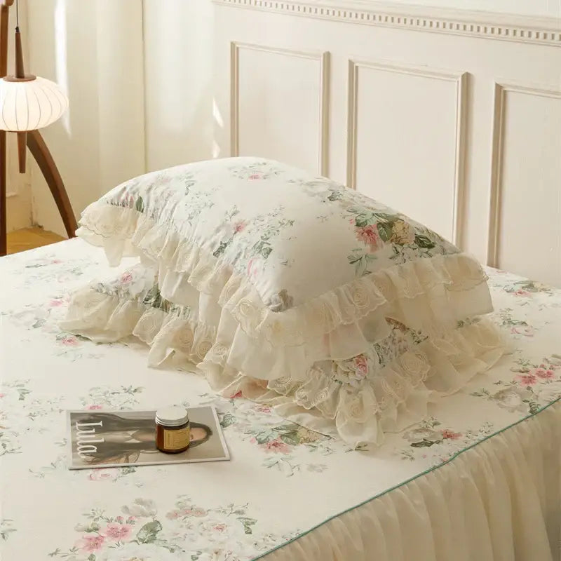 Cream-colored bedding set pillow with delicate floral pattern and layered ruffled lace trim for decorbites french country flowers