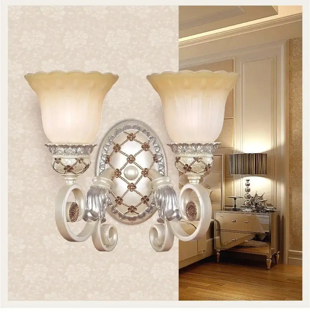 Silver ornate wall sconce with cream opaline glass shades and intricate metalwork for elegant living room lighting