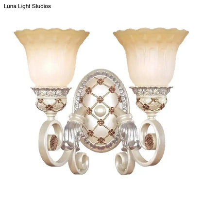 Antique white and gold wall sconce with two fluted opaline glass shades for elegant living room lighting